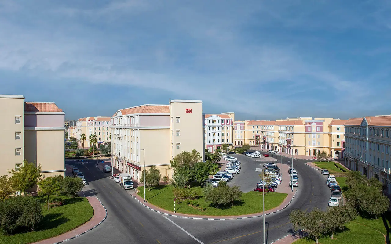 International City, street-level residential buildings and landscaped roundabout
