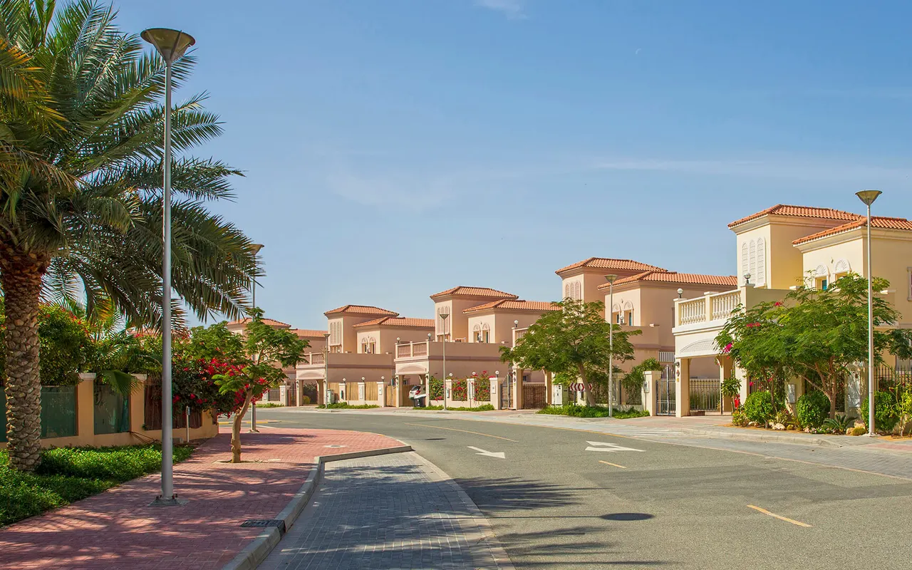 Completed Jumeirah Village Triangle villas beside a tree-lined residential street