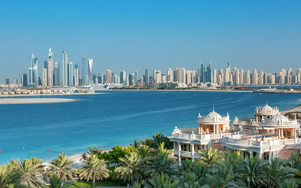 Palm Jumeirah waterfront villas with the Dubai Marina skyline across the water