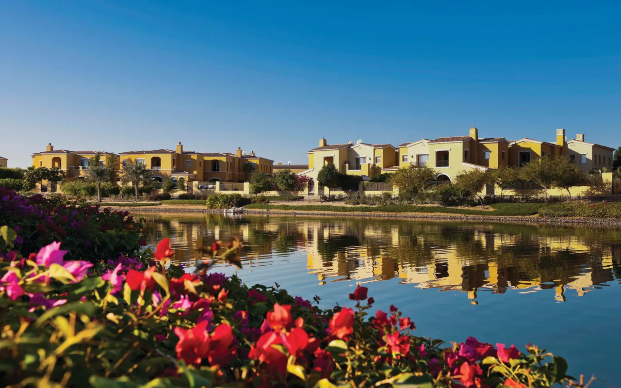 Completed Arabian Ranches villas reflected in a landscaped lake