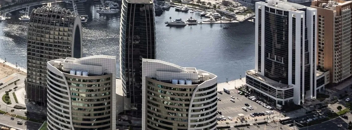 Canal-side office facades, marina and boats in Business Bay, cropped aerial photograph