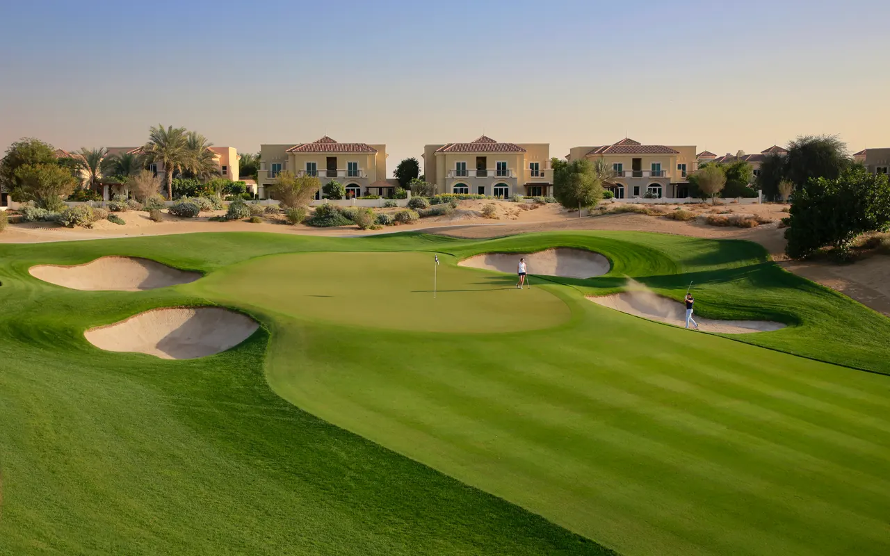 Golf fairway and completed villas beside The Els Club eleventh hole in Dubai Sports City. Area view: Dubai Sports City, where Majid Al Futtaim Tilal Al Ghaf Phase A's largest project, Aura, sits. Not a photograph of the developer's work.