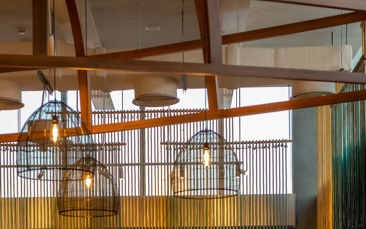 Pendant lights and ceiling details inside The First Collection restaurant in Jumeirah Village Circle