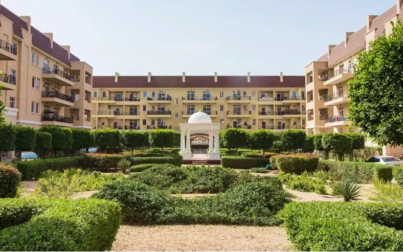 Landscaped courtyard between Green Community Motor City apartment buildings