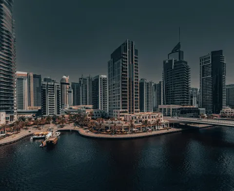 Dubai Marina waterfront and bridge beside completed residential towers