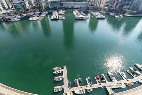 Boats moored in Dubai Marina beside Marina Mall