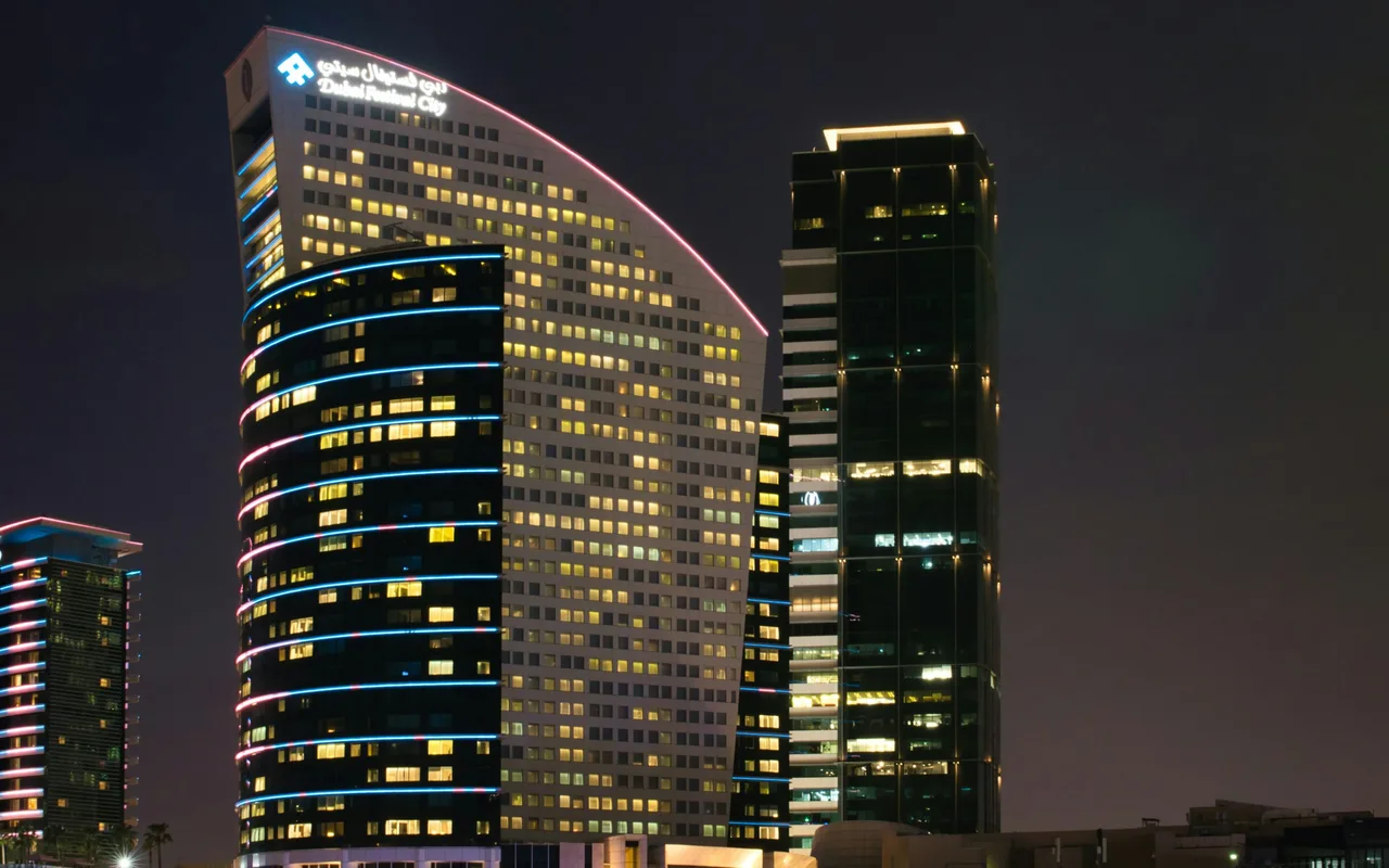 Completed hotel buildings illuminated at night in Dubai Festival City.