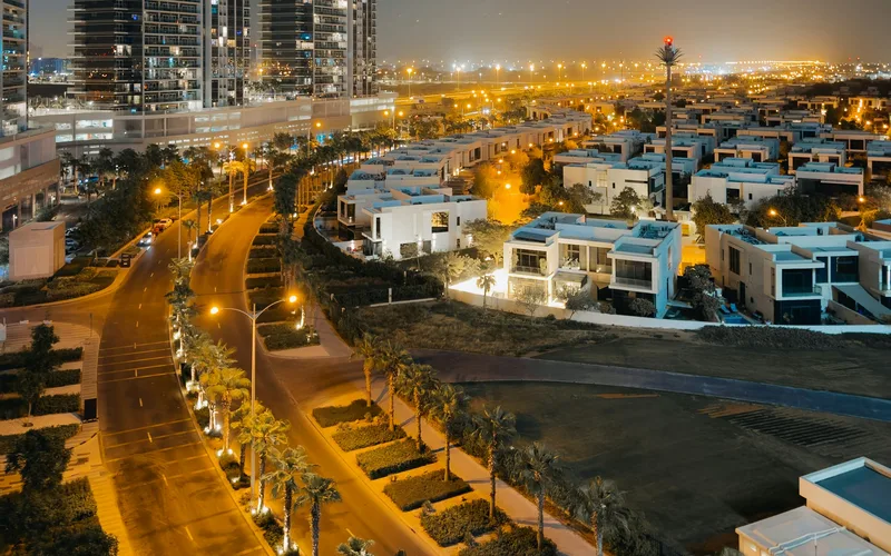 DAMAC Hills apartment towers and villa streets at night